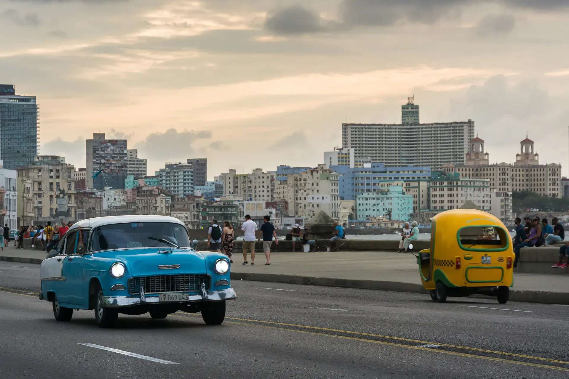 A classic car on Havana’s Malecón at dusk